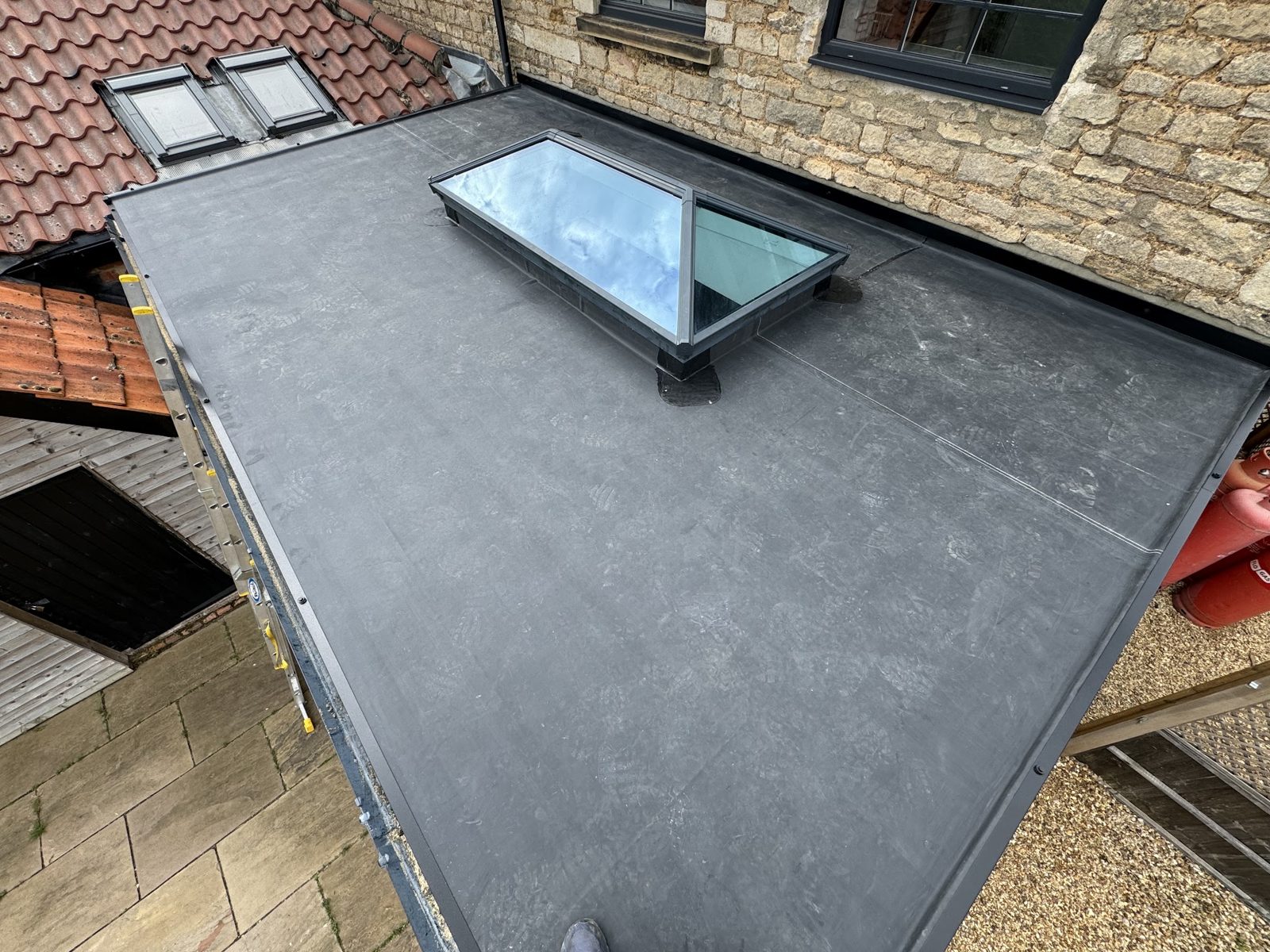 The same flat roof finished in a dark rubber membrane with the roof lantern fitted